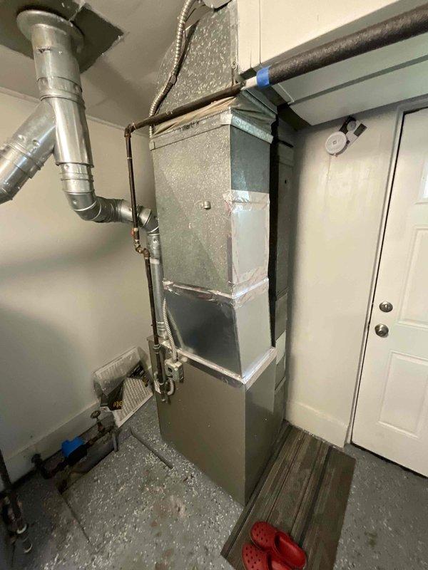 Conducted full system estimate for central air conditioning installation at residential property with existing furnace. Evaluated current HVAC setup including vertical furnace unit in garage/utility area with existing ductwork infrastructure, assessed electrical panel capacity for AC condenser connection, and documented refrigerant line routing requirements. Provided comprehensive quote for complete AC system integration with existing forced-air heating system to establish year-round climate control capability.