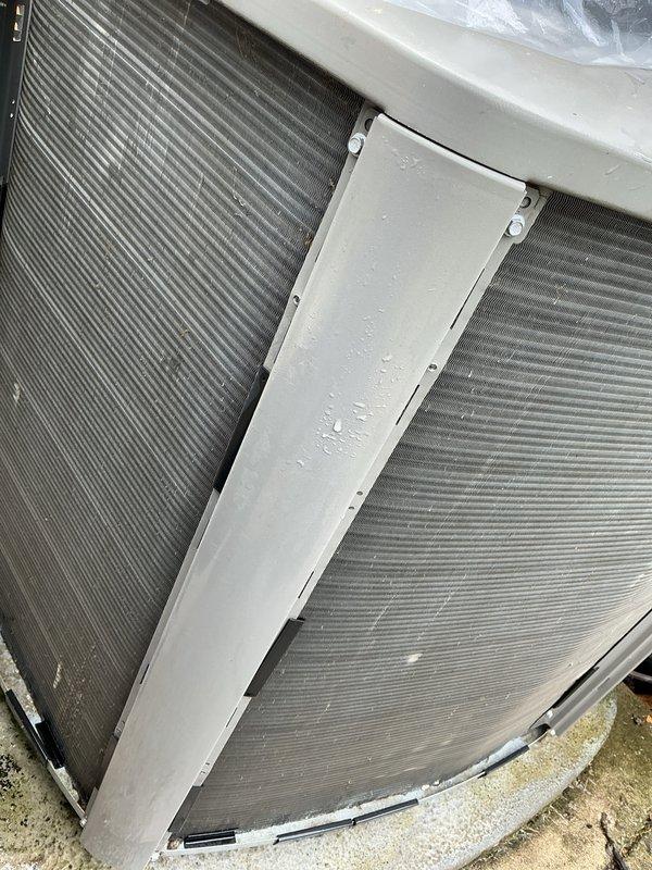 Completed comprehensive air conditioning maintenance on a 6-year-old residential cooling system. Upon arrival, performed visual inspection of outdoor condensing unit and discovered heavily clogged condenser coils with substantial accumulation of dust, dirt, lint, and debris restricting airflow. Thoroughly cleaned condenser coils using appropriate cleaning methods to restore proper heat exchange efficiency and system airflow. Removed thick layer of contamination from coil fins and protective screens. Inspected electrical connections, refrigerant lines, and mounting hardware for proper condition. Verified unit is properly secured on concrete pad. System operational following maintenance procedures. Documented equipment condition with photographs showing before and after coil cleaning. Unit returned to normal operating parameters with improved airflow through condenser section.