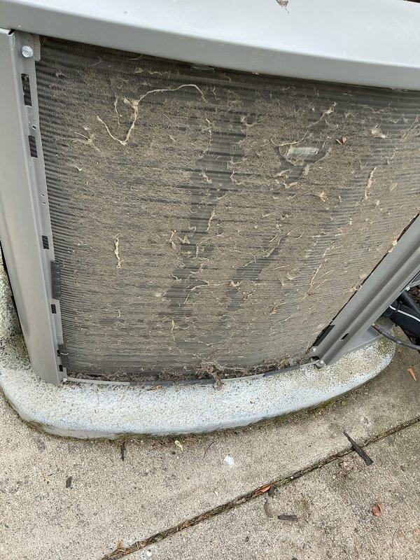 Completed comprehensive air conditioning maintenance on a 6-year-old residential cooling system. Upon arrival, performed visual inspection of outdoor condensing unit and discovered heavily clogged condenser coils with substantial accumulation of dust, dirt, lint, and debris restricting airflow. Thoroughly cleaned condenser coils using appropriate cleaning methods to restore proper heat exchange efficiency and system airflow. Removed thick layer of contamination from coil fins and protective screens. Inspected electrical connections, refrigerant lines, and mounting hardware for proper condition. Verified unit is properly secured on concrete pad. System operational following maintenance procedures. Documented equipment condition with photographs showing before and after coil cleaning. Unit returned to normal operating parameters with improved airflow through condenser section.