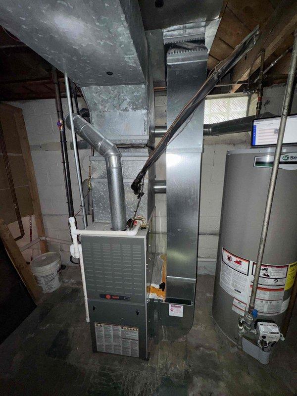 Responded to service call for non-functional air conditioning system affecting entire residence. Upon inspection, confirmed 25-year-old AC unit requires complete replacement due to age and compromised wiring caused by external damage. Documented existing HVAC infrastructure in basement mechanical room, including furnace, ductwork configuration, and current system layout to provide comprehensive replacement estimate.