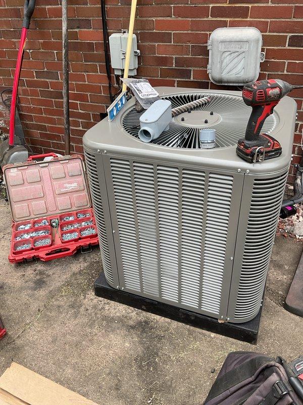 Completed installation of 2-ton air conditioning condenser unit with matching evaporator coil system. Obtained mechanical, electrical, and air conditioning permits prior to installation. Installed new 100-amp electrical circuit with disconnect box and proper conduit routing to support the new equipment. Mounted condenser unit on concrete pad against exterior brick wall with proper clearances for airflow and service access. Connected refrigerant lines, electrical wiring, and condensate drainage system. System tested and operational upon completion.