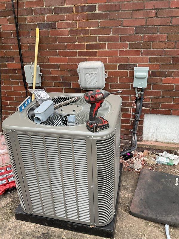 Completed installation of 2-ton air conditioning condenser unit with matching evaporator coil system. Obtained mechanical, electrical, and air conditioning permits prior to installation. Installed new 100-amp electrical circuit with disconnect box and proper conduit routing to support the new equipment. Mounted condenser unit on concrete pad against exterior brick wall with proper clearances for airflow and service access. Connected refrigerant lines, electrical wiring, and condensate drainage system. System tested and operational upon completion.
