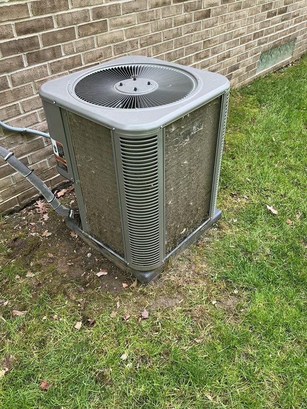 Completed annual cooling maintenance on residential split system air conditioning unit. Performed comprehensive system diagnostics using digital manifold gauges to measure refrigerant pressures and temperatures, verified proper operating parameters, and documented equipment condition. Unit exterior showed significant dirt and debris accumulation on condenser coils and housing, which was addressed as part of routine maintenance procedures to ensure optimal heat exchange efficiency and system performance.