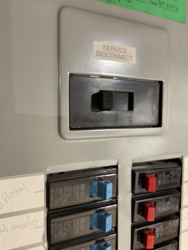 Completed comprehensive whole home electrical inspection of main service panel and distribution system. Evaluated service disconnect switch operation and verified proper labeling, documented dual-column circuit breaker configuration with color-coded toggle indicators for easy circuit identification. Inspected all branch circuit breakers for proper seating, secure connections, and appropriate amperage ratings. Assessed wire routing and organization within panel enclosure, confirmed proper conductor sizing and termination integrity at main lugs and individual breaker connections. Photographed panel configuration showing handwritten circuit directory identifying disposal and dishwasher circuits, noted mixed breaker indicator colors (blue and red) for visual circuit differentiation. Verified main disconnect functionality and panel grounding system compliance. All components found operational with no immediate safety concerns identified during inspection period.