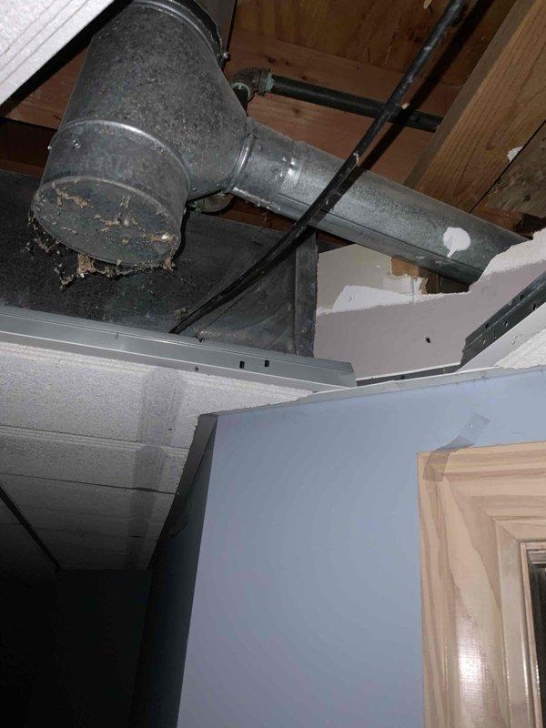 Conducted comprehensive assessment of 16-year-old HVAC system to provide full replacement estimate. Inspected existing air conditioning unit and furnace, both at end of service life. Evaluated electrical panel configuration and capacity for new system installation. Documented deteriorated ductwork in attic space, noting compromised elbow joint with visible insulation damage and significant dust accumulation throughout system. Assessed structural support requirements and existing duct connections. Provided detailed replacement quote for complete system upgrade including new furnace, air conditioner, and necessary ductwork modifications to address identified deficiencies.