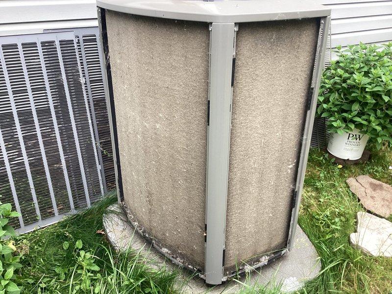 Responded to service call for Lennox air conditioning unit not cooling despite running. Upon inspection, found outdoor condenser unit with severely clogged condenser coils and filters restricting airflow. Unit was only 11 months old and still under parts and labor warranty. Cleaned condenser coils and replaced dirty filters to restore proper airflow through the system. Verified unit operation, confirmed adequate cooling performance restored, and system returned to normal functionality.