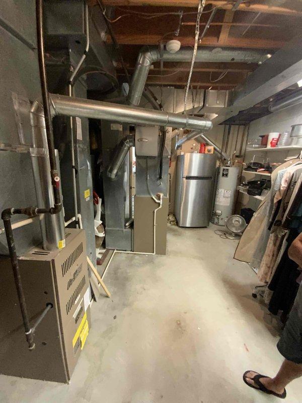 Completed comprehensive HVAC estimate for air conditioning replacement at a 30-year-old colonial home with forced air natural gas heating system and basement installation. Evaluated existing mechanical room configuration including current furnace, ductwork distribution, electrical panel capacity, and available space for new equipment installation, presenting options for both standalone A/C replacement and whole home comfort package upgrade.