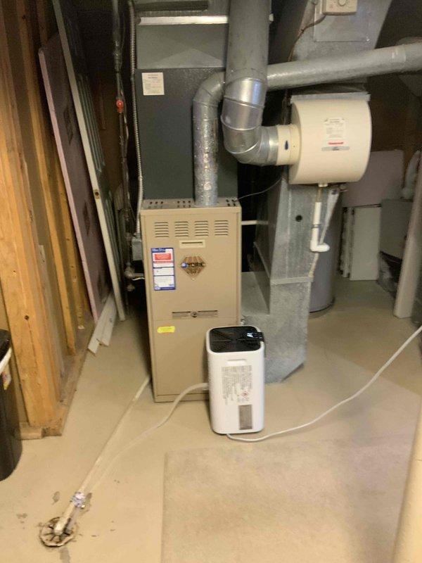 Completed on-site assessment of 16-year-old furnace and air conditioning system for replacement estimate. Evaluated existing HVAC equipment in basement mechanical room, including furnace unit with attached humidifier and ductwork configuration, and inspected exterior condensing unit location at side of residence. Provided comprehensive replacement quote for new furnace and AC system installation to address aging equipment requiring immediate replacement.