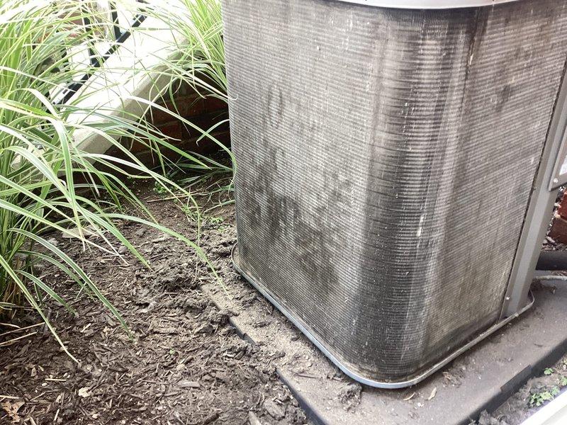 Responded to service call for residential A/C unit producing loud squeaking noises and experiencing reduced cooling efficiency. Upon arrival, found outdoor condenser unit heavily coated with dirt, debris, and grime on exterior casing and coil surfaces. Unit showed signs of extended outdoor exposure with significant accumulation of dust, leaves, and organic matter. Vegetation and weeds had grown in close proximity to equipment, restricting airflow around the unit.

Performed thorough inspection of condenser unit and identified excessive buildup on condenser coils as primary cause of reduced cooling capacity and increased operating noise. Cleaned condenser coils using appropriate cleaning solution and pressure washing techniques to remove accumulated debris. Cleared vegetation and organic matter from around unit perimeter to restore proper airflow clearance. Inspected fan motor and blower assembly for mechanical issues contributing to squeaking noise. Lubricated fan motor bearings and ve