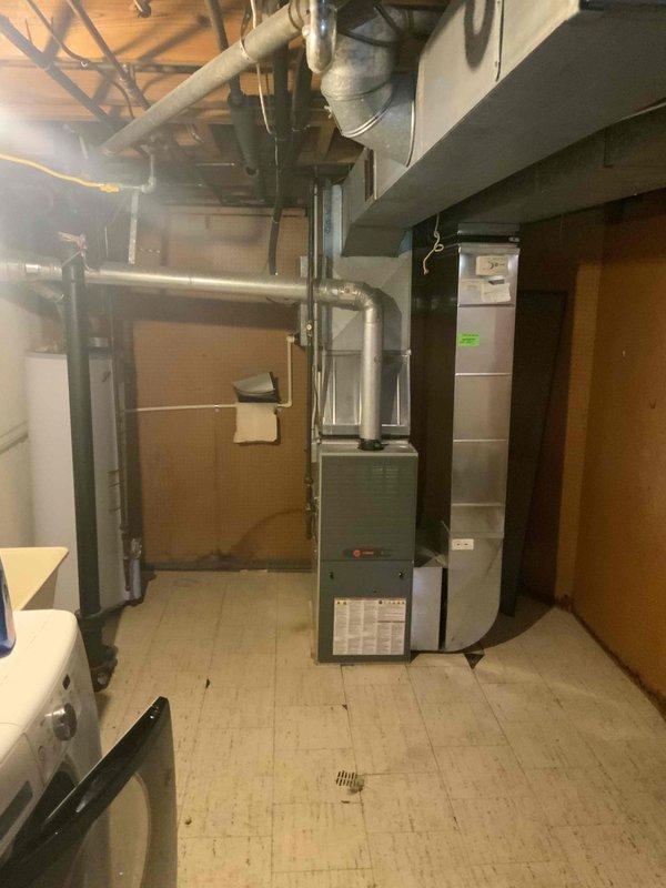 Completed comprehensive whole home comfort system evaluation for non-operational air conditioning unit and aging furnace system. Assessed outdoor condenser unit positioned on exterior pad with proper clearances and landscaping, evaluated basement-installed forced air furnace with existing ductwork infrastructure, and provided detailed estimate for complete HVAC system replacement including new high-efficiency equipment specifications and installation requirements.