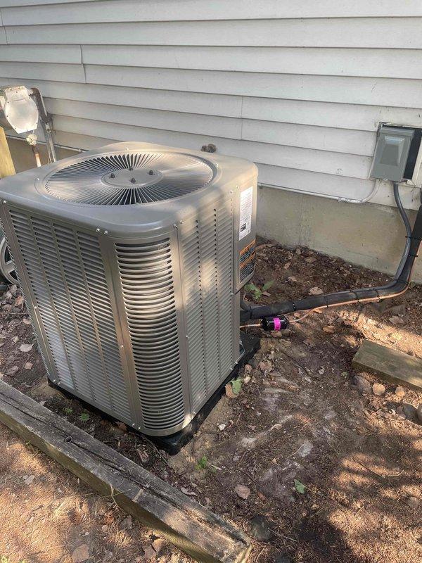 Successfully completed installation of a 2-ton air conditioning system with evaporator coil at rear exterior location. The outdoor condenser unit was positioned on an existing concrete pad adjacent to the foundation, with refrigerant lines properly insulated and routed to the house. Electrical disconnect box was installed on the exterior wall for service accessibility, and all refrigerant connections were completed and secured. Permits were requested for mechanical and air conditioning work prior to installation, and all components were reconnected and commissioned per manufacturer specifications.