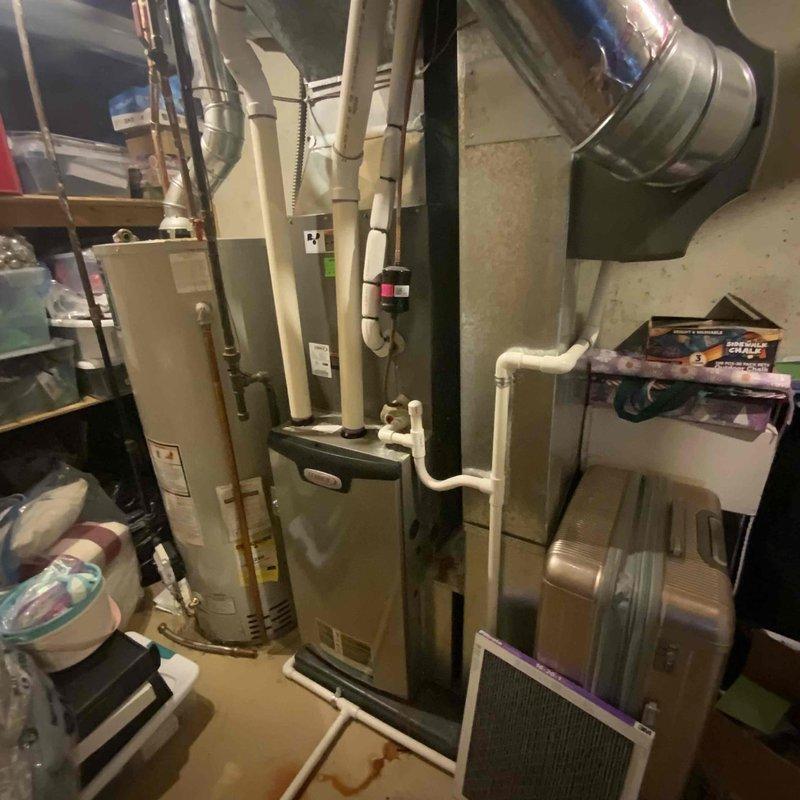 Conducted full system evaluation on 7-year-old Lennox HVAC system experiencing inadequate cooling performance with temperature delta consistently measuring only 10-12 degrees, previously diagnosed with failed compressor. Inspected outdoor condenser unit with gray rounded housing positioned on concrete patio, noting refrigerant line connections and electrical conduit routing along exterior wall. Evaluated indoor furnace unit and air handler located in basement utility area, examining ductwork connections and system configuration. Documented equipment condition through comprehensive photography of both outdoor and indoor components. Provided complete system replacement estimate as repair of compressor deemed not cost-effective given age of equipment and performance issues.