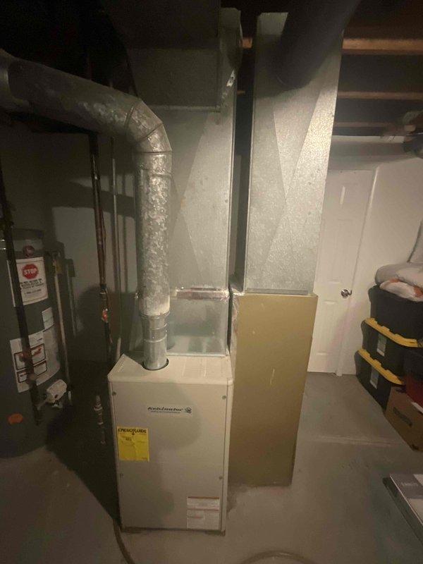 Completed HVAC estimate for replacement of existing Kelvinator heating and cooling system in residential duplex unit. Documented current equipment condition including furnace, ductwork configuration, and surrounding utility infrastructure to provide comprehensive replacement recommendations and specifications.