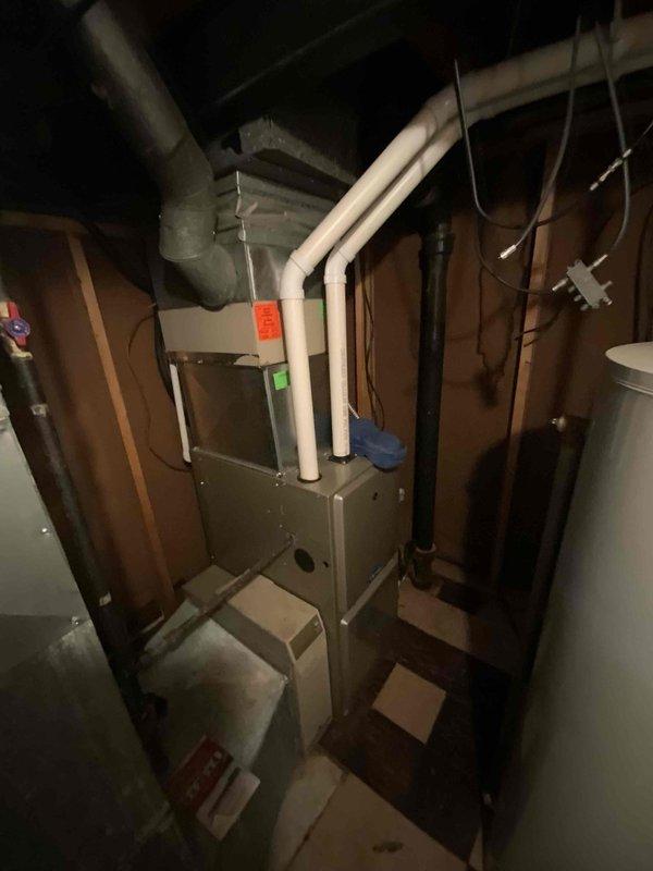 Conducted a comprehensive full system estimate for a 16-year-old residential air conditioning system. Evaluated existing HVAC equipment located in the basement utility area, including the furnace unit with associated PVC venting, flexible ductwork, and electrical connections. Documented current system configuration through photographic assessment, noting equipment age and operational status indicators. Reviewed electrical panel capacity and existing infrastructure to determine compatibility requirements for potential system replacement. Customer indicated need for replacement within the next couple of weeks.