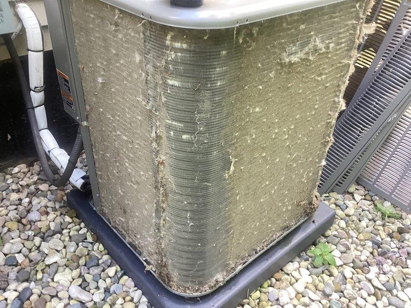 Completed comprehensive AC tune-up and furnace maintenance on 10-year-old HVAC system at recently purchased condo. Outdoor condenser unit showed significant dirt and debris accumulation on coil fins and housing, requiring thorough cleaning to restore proper airflow and heat transfer efficiency. Addressed neglected humidifier with moldy filter and foul odor by replacing filter media and sanitizing unit. Performed standard maintenance procedures including refrigerant level check, electrical connections inspection, thermostat calibration, and system operational testing. All components now functioning properly with improved air quality and system performance restored.