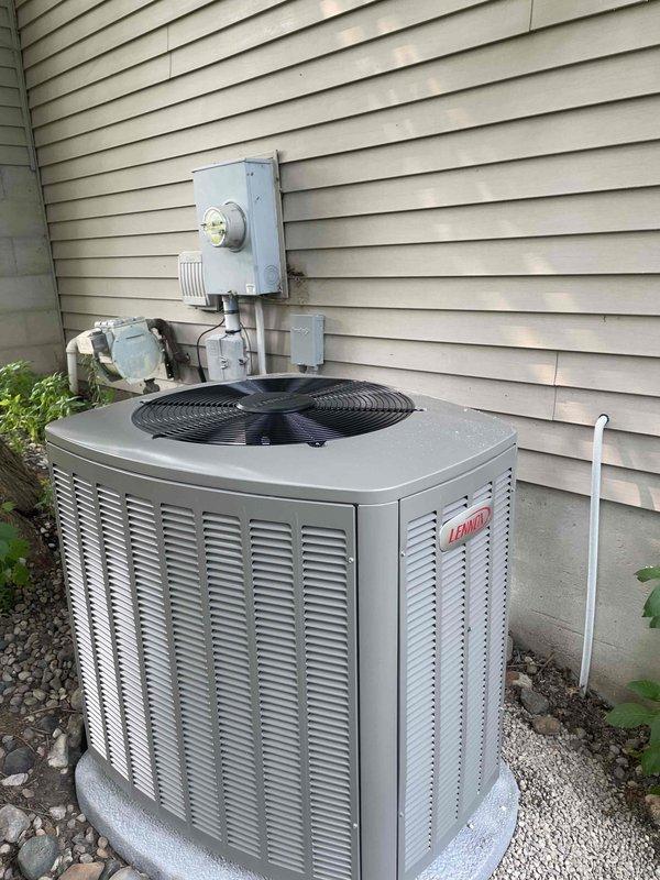 Completed full HVAC system installation including a 90,000 BTU high-efficiency furnace and 3-ton air conditioning unit. Installed Lennox outdoor condensing unit on gravel pad against exterior wall with proper electrical disconnect and conduit routing, along with PVC condensate drain line. Positioned furnace in basement mechanical room with dual PVC intake and exhaust venting, integrated black rectangular supply ductwork, and reconnected all necessary utilities. Mechanical and electrical permits were obtained prior to installation, and all systems were tested and operational upon completion.