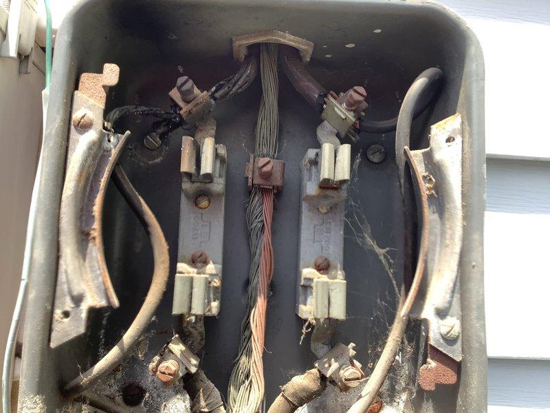 Responded to callback for AC unit not cooling properly. Upon arrival, inspected exterior electrical service panel and AC main disconnect per customer request following their contact with utility company regarding power supply concerns. Previous technician had not accessed furnace area or checked fusing as requested. Verified proper voltage at meter and service panel, inspected circuit breakers and AC disconnect switch, documented electrical connections and service entrance components. Found electrical supply adequate with no immediate safety concerns at disconnect panel. Photographed electrical service equipment showing weathered connections and age-related corrosion on bus bars and terminals typical of older installations. Confirmed 15-year-old outdoor AC unit receiving proper power supply at disconnect.