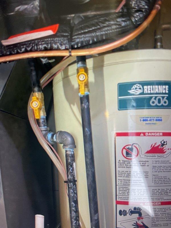Completed violation repair callback to address gas line code deficiencies identified during initial inspection. Rebuilt gas piping system by installing a proper manifold configuration to serve both the furnace and water heater, ensuring each appliance now has its own dedicated shut-off valve, union, and sediment trap as required by code. Corrected improper sediment trap installation on hot water tank and replaced non-compliant merchant coupling with approved rigid fitting coupling.