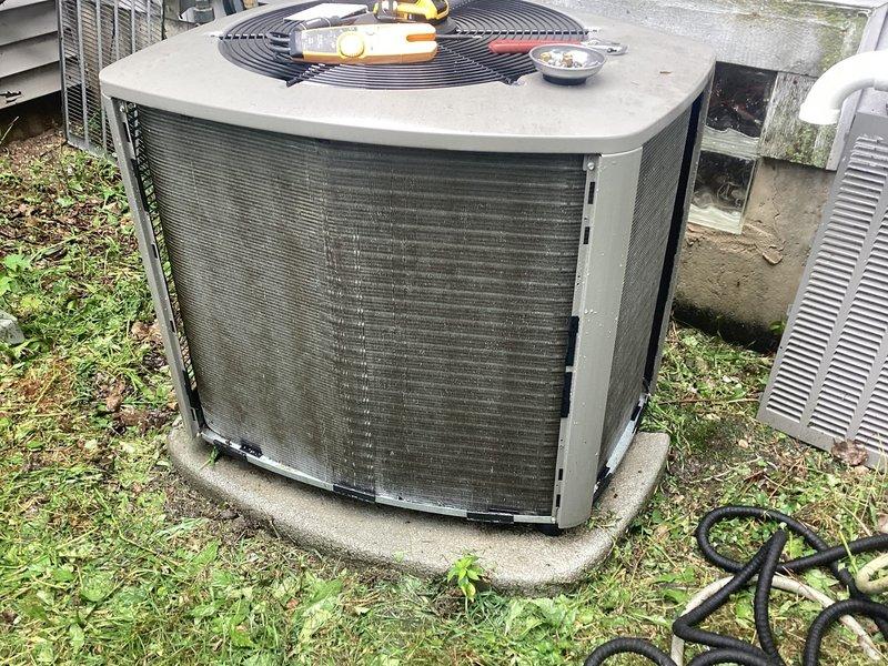 # No Cooling - Restricted Airflow Due to Debris Accumulation

Responded to no cooling complaint on 2-year-old residential air conditioning system. Upon arrival, performed visual inspection of outdoor condensing unit and identified severe airflow restriction caused by extensive debris accumulation on condenser coil screens. Filter screens were completely obstructed with thick layer of grass clippings, leaves, dirt, and organic matter, preventing proper air circulation through the unit.

Removed top panel and fan assembly to access condenser coils. Carefully cleaned all exterior screens and condenser coil fins, removing matted debris buildup. Utilized appropriate cleaning tools and techniques to restore full airflow capacity without damaging delicate aluminum fins. Verified condenser fan motor operation and inspected electrical connections.

Reassembled unit, secured all panels and fasteners. System tested and confirmed proper operation with adequate airflow and cooling performance resto