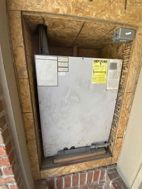 Performed full system estimate on 16-year-old First Company HVAC unit installed in interior wall compartment with OSB framing. Assessed existing equipment condition, documented installation configuration including electrical conduit routing and brick base construction, and reviewed previous mechanical inspection approval from 2015. Provided comprehensive replacement options and discussed available service credit toward new system installation with customer requiring immediate replacement.
