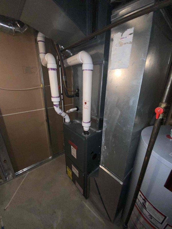 Provided comprehensive estimate for complete HVAC system replacement in basement location, including non-functional air conditioning unit and furnace dating from 1985. Assessed existing equipment configuration with water heater, evaluated current ductwork connections, PVC venting arrangements, and available space constraints for new installation recommendations.
