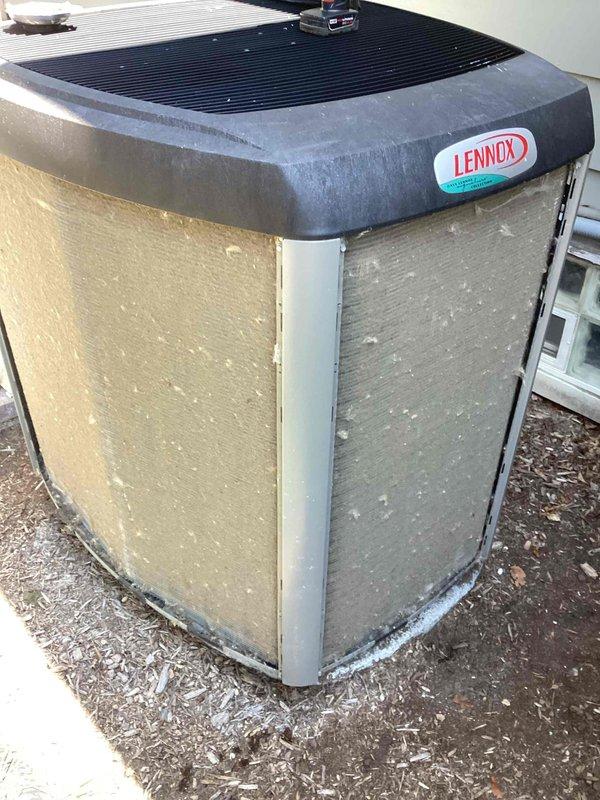 Completed scheduled maintenance on Lennox residential air conditioning condenser unit. Performed system inspection, replaced air filter, and documented unit condition showing dirt and debris accumulation on exterior grilles and panels requiring cleaning attention.