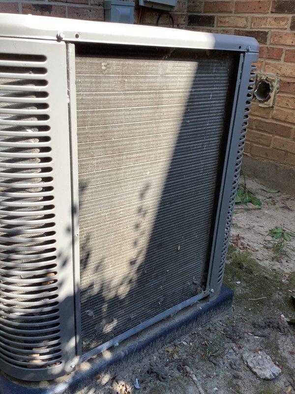 Responded to service call for reported water leak on 9-year-old system located in basement. Upon arrival, inspected outdoor condensing unit and found excessive accumulation of environmental debris, including cottonwood seeds, dust, and dirt coating internal components and condenser coil fins. The heavy debris buildup was restricting airflow through the coil assembly and likely contributing to system performance issues. Removed access panels and documented condition with photos showing significant contamination throughout the unit's interior cavity. The debris accumulation on the condenser coil was causing reduced heat transfer efficiency and potential drainage problems. Homeowner requested tune-up and air conditioning maintenance if time permitted. Condenser coil cleaning and system maintenance recommended to restore proper airflow and prevent future water-related issues from restricted drainage.