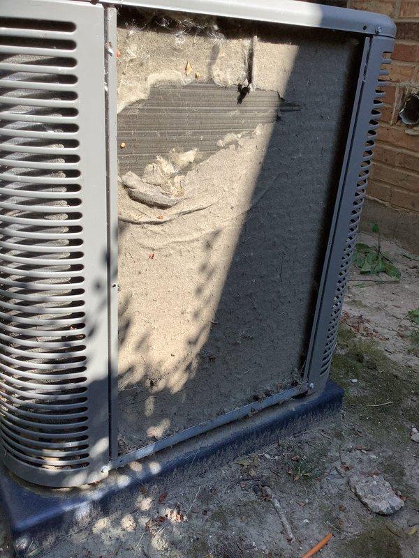 Responded to service call for reported water leak on 9-year-old system located in basement. Upon arrival, inspected outdoor condensing unit and found excessive accumulation of environmental debris, including cottonwood seeds, dust, and dirt coating internal components and condenser coil fins. The heavy debris buildup was restricting airflow through the coil assembly and likely contributing to system performance issues. Removed access panels and documented condition with photos showing significant contamination throughout the unit's interior cavity. The debris accumulation on the condenser coil was causing reduced heat transfer efficiency and potential drainage problems. Homeowner requested tune-up and air conditioning maintenance if time permitted. Condenser coil cleaning and system maintenance recommended to restore proper airflow and prevent future water-related issues from restricted drainage.