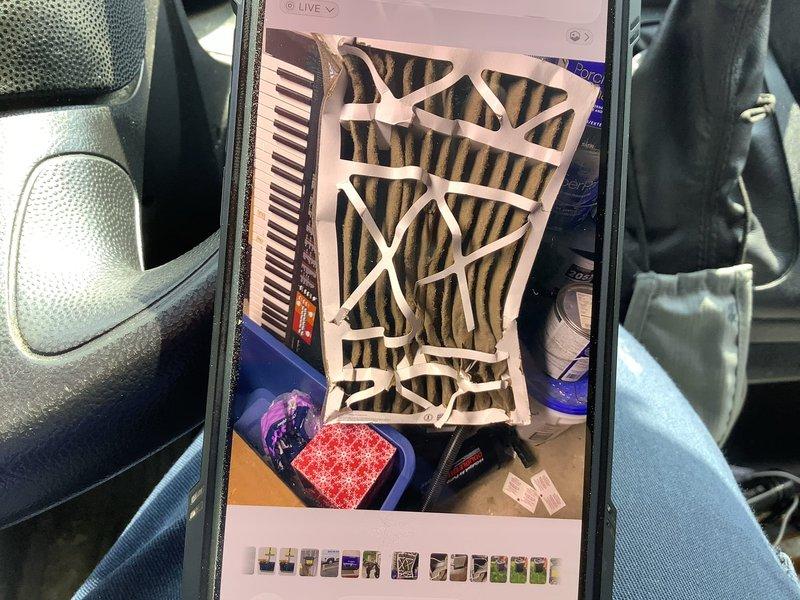 Responded to no cooling complaint on 7-year-old residential split system air conditioning unit. Upon arrival, performed visual inspection of outdoor condensing unit positioned on concrete pad adjacent to structure. Conducted system diagnostics and identified severely contaminated air filter as primary cause of reduced airflow and cooling capacity. The pleated filter exhibited significant dust accumulation and brown discoloration throughout, restricting proper air circulation and causing system performance issues. Replaced dirty filter with new unit to restore adequate airflow and system operation.