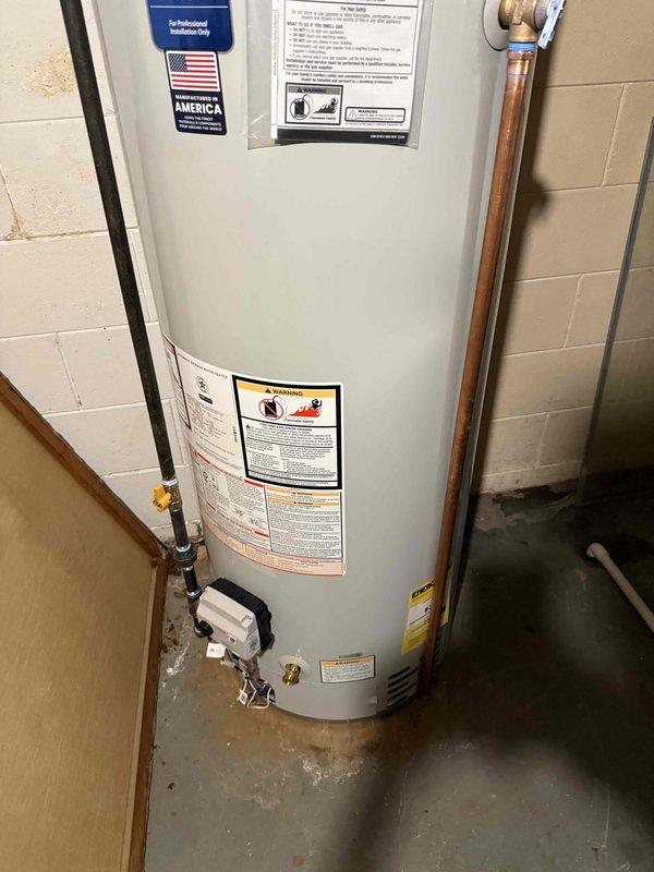 Installed a new 50-gallon Bradford White residential tank-type water heater in basement utility area. Removed existing unit and connected new water heater with copper supply piping, brass shut-off valves, and proper venting through aluminum flue pipe. Completed all hot and cold water connections, installed temperature and pressure relief valve with discharge piping, and ensured proper clearances per manufacturer specifications. Tested unit operation, verified all connections for leaks, and confirmed proper venting and combustion air supply. Installation performed in compliance with local plumbing codes and permit requirements.
