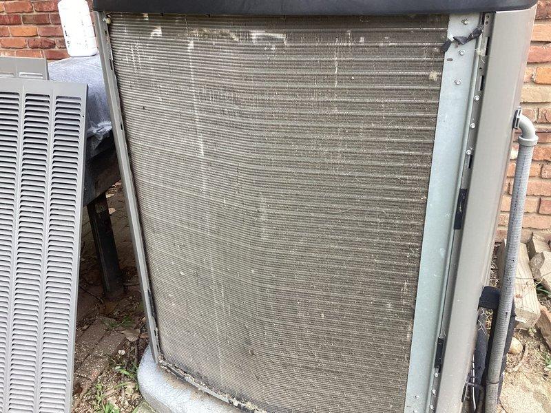 Responded to service call for 5-year-old air conditioning system that was producing a whining noise during operation and had been shut down by occupant. Performed diagnostic inspection of outdoor condenser unit located against exterior brick wall and basement equipment. Identified failed component requiring parts replacement, completed repair under parts warranty coverage, and restored system to normal operation.