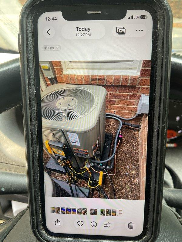 Completed callback to reposition 2-ton air conditioning condenser unit 90 degrees to conceal service ports and manufacturer labels from front-of-building view. Disconnected refrigerant lines and electrical connections, rotated unit on pad, and reconnected all components. Verified proper operation of outdoor condenser unit serving 70K BTU furnace system with evaporator coil, confirmed all connections secure and unit running within manufacturer specifications.