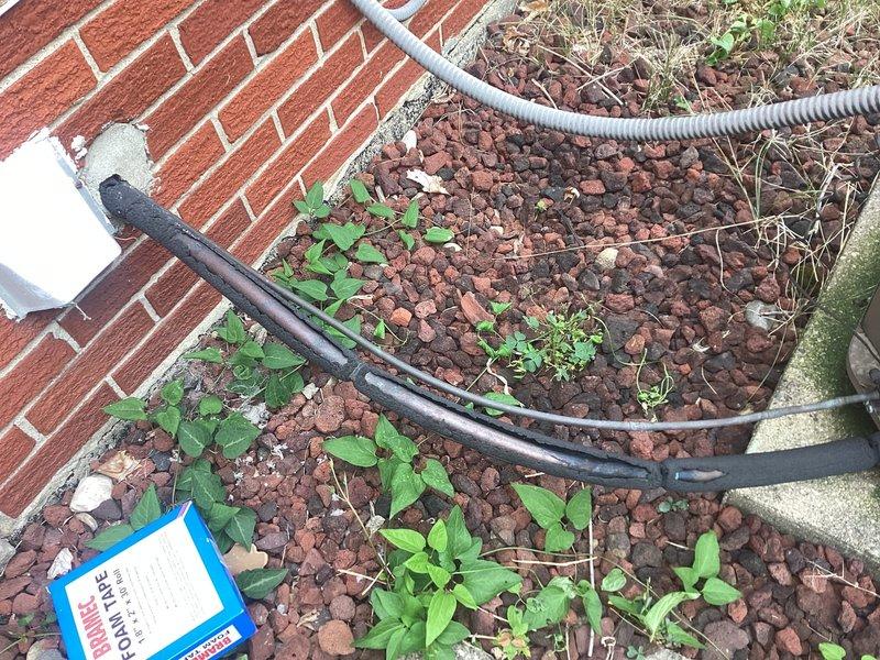 Responded to service call for exposed electrical wiring at outdoor A/C unit located at basement level. Inspected exterior condensing unit and associated electrical conduits running along building foundation through landscaped area. Properly secured and re-wrapped exposed wiring connections using appropriate electrical tape and protective conduit materials to ensure code compliance and prevent weather exposure. Verified all electrical connections were properly insulated and protected from environmental elements. Unit tested and operational upon completion.