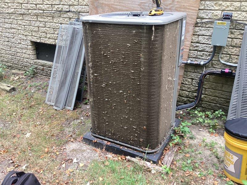 Responded to service call for one-year-old system displaying error code ID 39 with "service urgent" message on thermostat. Located basement-installed equipment and outdoor condenser unit. Upon inspection, found condenser unit with significant dirt, debris, and organic matter accumulation on exterior cabinet and coil surfaces, which can restrict airflow and impact system performance. Documented equipment condition with photographs showing heavy contamination on condenser panels and surrounding area. Addressed error code and verified system operation. Both parts and labor remain under manufacturer warranty coverage.