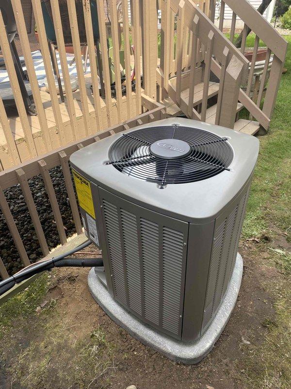 Completed installation of 2-ton Lennox air conditioning system with matching evaporator coil at residential property. Unit positioned on concrete pad in right side yard per permit specifications, with refrigerant lines and electrical conduit properly routed and connected. System tested and verified operational upon completion of reconnection procedures.
