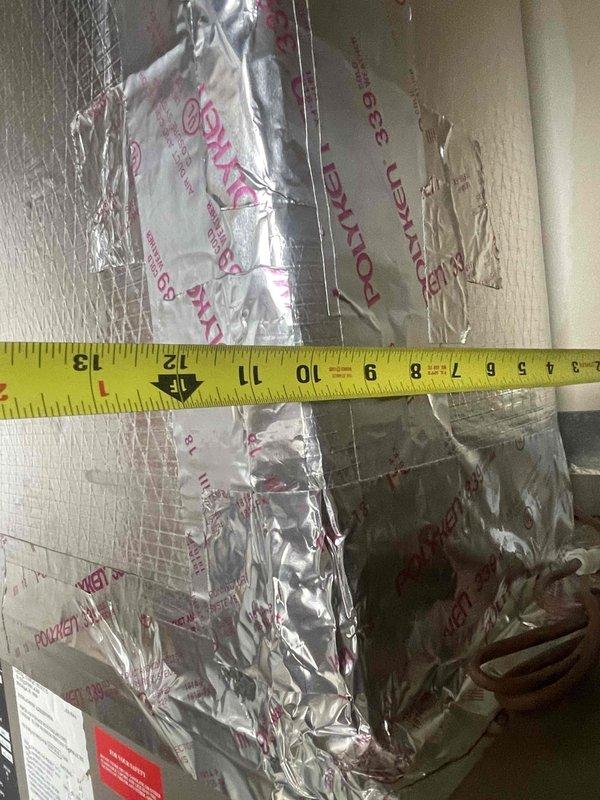 Provided estimate for replacement of air conditioning and furnace system in first-floor condo unit. Current equipment dating from 2008 is still operational but approaching end of service life. Existing HVAC system is located in mechanical room on enclosed porch area. Measured existing unit dimensions and documented current equipment specifications, including CPG305 model operating at 208-230V with 11.1 RLA and 78 LRA ratings. Assessed installation space constraints and insulation conditions to determine proper sizing and placement requirements for replacement equipment.
