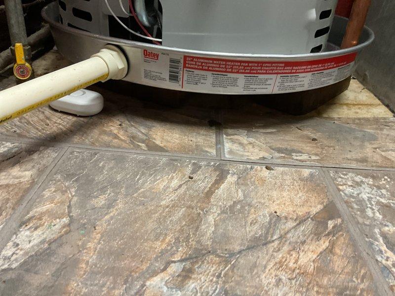 Completed violation repair call back for previously installed 40-gallon hot water heater. Corrected T&P discharge line to terminate properly above floor level per code requirements, upgraded venting system to proper B-vent configuration, installed code-compliant drain pan beneath water heater to protect against potential water damage, and placed and activated water alarm system. All plumbing code violations have been addressed and corrected, with mechanical permit work completed and unit properly reconnected and operational.
