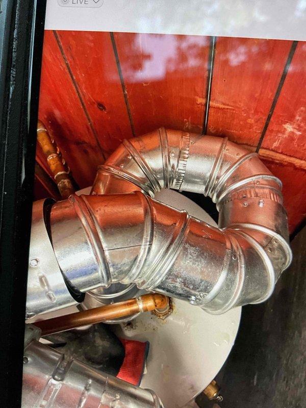 Completed violation repair call back for previously installed 40-gallon hot water heater. Corrected T&P discharge line to terminate properly above floor level per code requirements, upgraded venting system to proper B-vent configuration, installed code-compliant drain pan beneath water heater to protect against potential water damage, and placed and activated water alarm system. All plumbing code violations have been addressed and corrected, with mechanical permit work completed and unit properly reconnected and operational.