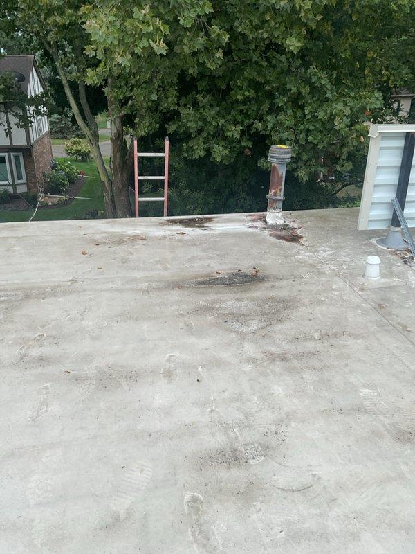 Conducted comprehensive site evaluation for commercial rooftop unit replacement on single-story building. Accessed roof via ladder to assess existing RTU condition, documented electrical disconnect switch showing weathering and corrosion, and photographed flat membrane roof surface displaying age-related deterioration. Coordinated estimate requirements with building tenant and property owner to establish approval process for full system replacement.