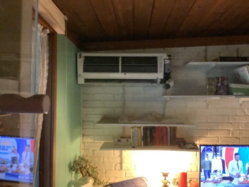 Responded to service recall for reported severe leaking from mini split system. Upon arrival, inspected indoor wall-mounted unit and outdoor condenser for source of water leakage and assessed overall system operation. Examined air filters and found damaged screens with holes requiring replacement. Performed exterior condenser cleaning by hosing off outdoor unit to remove debris and improve heat exchange efficiency. Evaluated system heating capacity concerns related to performance below 35°F ambient temperature and documented undersized equipment for customer's heating load requirements.