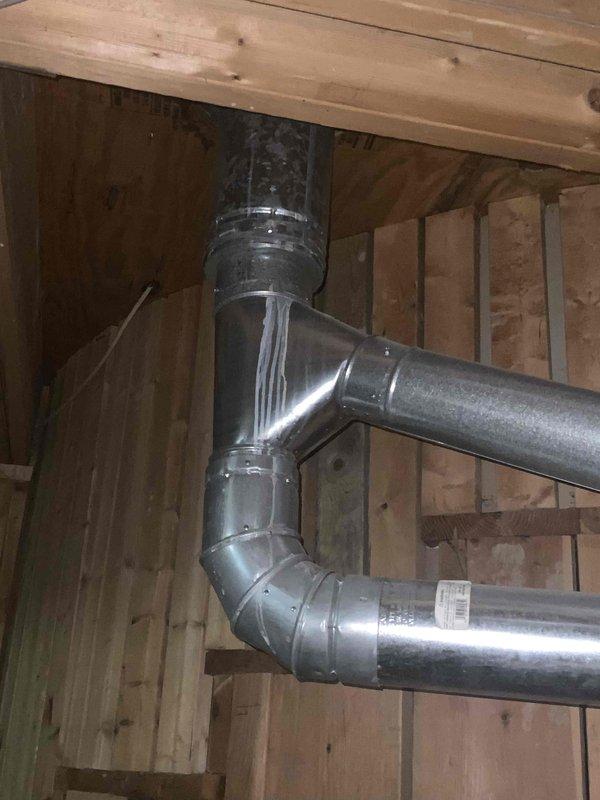 Provided comprehensive estimate for replacement of 30+ year old non-operational natural gas furnace located in basement. Assessed existing HVAC system including ductwork configuration, exhaust venting, and spatial requirements for new equipment installation. Documented current system layout with metal ductwork runs, existing furnace unit with exhaust vent pipe, and proximity to water heater to determine optimal replacement specifications and installation approach.