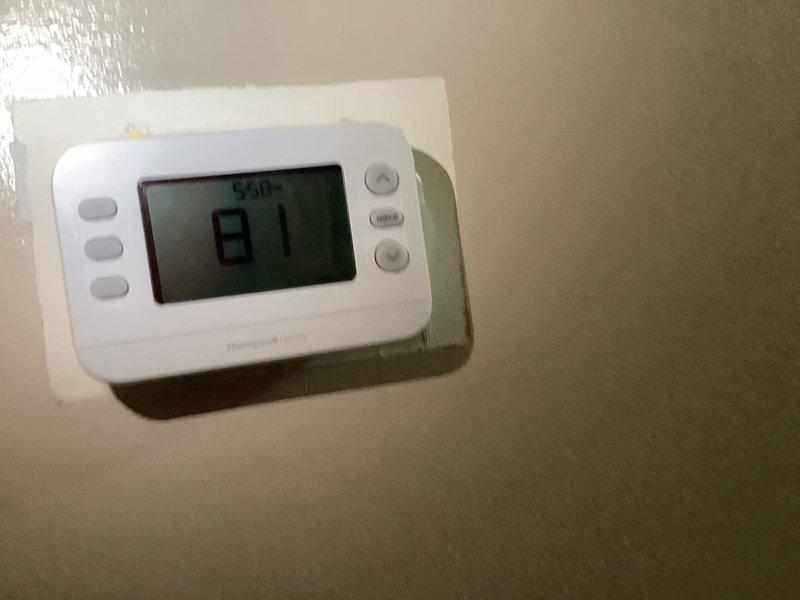 Responded to no cooling complaint on 5-year-old central air conditioning system blowing warm air. Inspected outdoor condenser unit and found capacitor showing signs of failure. Evaluated Honeywell thermostat operation and confirmed proper communication between thermostat and system. Replaced dual-run capacitor to restore proper compressor and fan motor operation. System tested and verified cooling functionality restored to normal operating parameters.