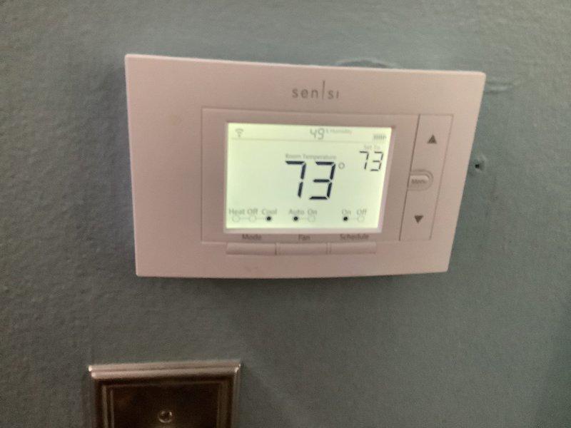 Responded to callback for 4-year-old AC system with ongoing cooling and dehumidification issues following two previous service visits where refrigerant adjustments and blower speed modifications were made. Conducted comprehensive system evaluation and documented thermostat readings showing 73°F room temperature with heating mode inadvertently active. Corrected thermostat programming, verified proper system operation in cooling mode, and escalated to field supervisor for review of previous refrigerant charge adjustments to ensure long-term resolution of humidity control concerns.