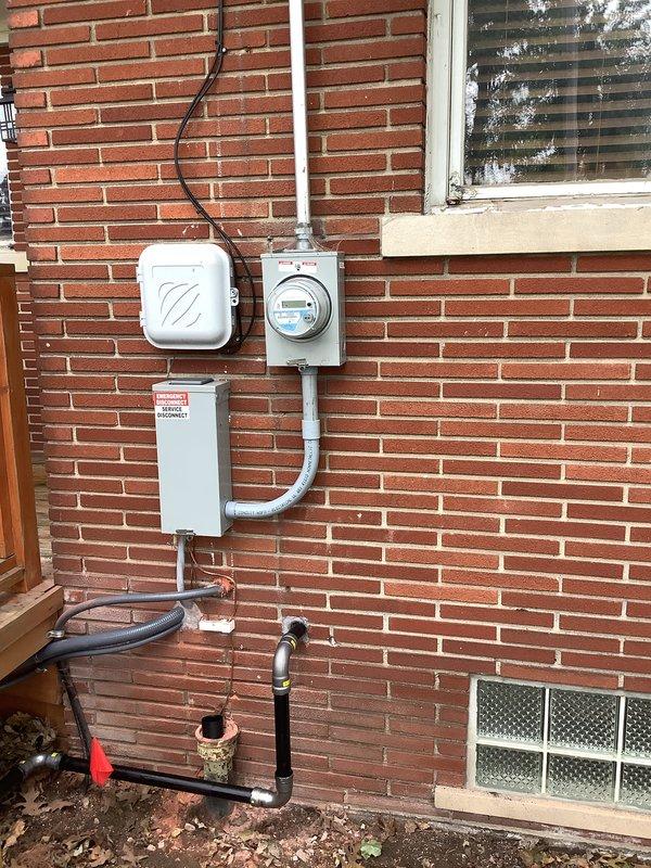 Completed installation of 20kW RCA standby generator with 100-amp automatic transfer switch at residential property. Installed exterior-mounted electrical components including generator disconnect, meter socket, and transfer switch enclosure on brick wall with proper conduit routing. Ran white PVC conduit from transfer switch to ground penetration point and installed black flexible gas line conduit for fuel supply connection. All electrical connections completed per code requirements with appropriate overcurrent protection and grounding. Permits were previously requested for mechanical, electrical, generator, and gas piping work prior to installation.