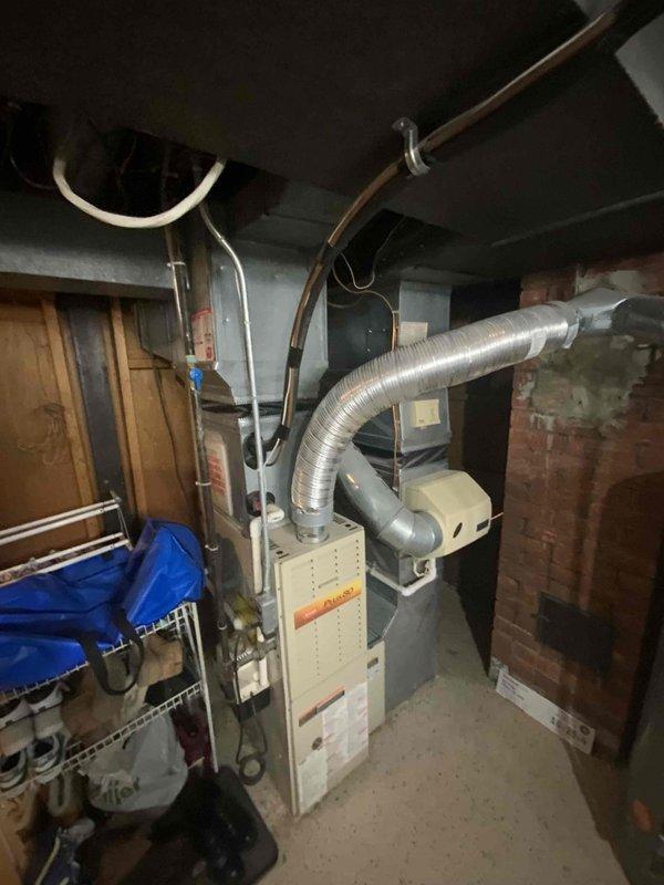 Conducted comprehensive assessment of 20+ year old non-operational air conditioning system located in backyard and natural gas furnace in basement utility area. Evaluated existing outdoor condenser unit with vertical coil component and indoor furnace with associated ductwork and PVC venting system. Provided replacement estimate for complete HVAC system upgrade to restore cooling and heating functionality.
