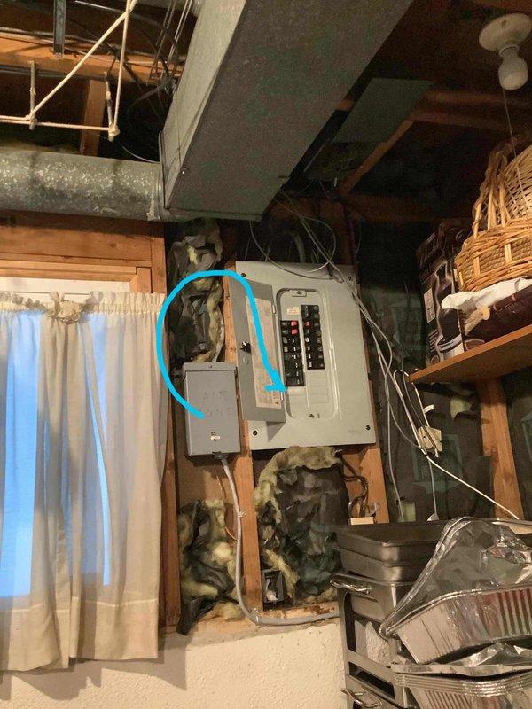 Conducted site evaluation for new whole home generator installation. Assessed existing electrical panel configuration in unfinished basement utility area, documented current 240V service capacity and available breaker positions for generator interlock or transfer switch integration. Reviewed installation requirements for Kohler generator system and provided consultation on Generac options for comparison. Photographed electrical panel layout, service entrance location, and surrounding workspace to determine optimal equipment placement and transfer switch mounting position. Identified adequate clearances and accessibility for future generator pad installation and electrical connections to main service panel.