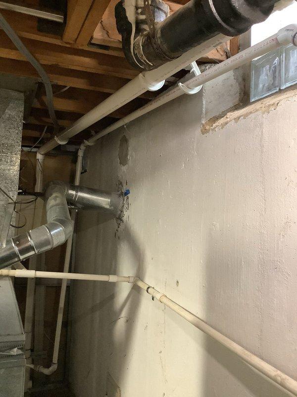 Completed comprehensive plumbing and HVAC system modifications in basement utility area. Reworked entire drain system, connecting into existing 2" PVC line with proper pitch and securing. Corrected furnace and water heater venting configuration using appropriate metallic ductwork and fittings to ensure safe exhaust operation. Removed existing humidifier unit from system. Installed replacement motor for HVAC equipment. All work performed to code with proper pipe supports and duct connections verified for functionality.