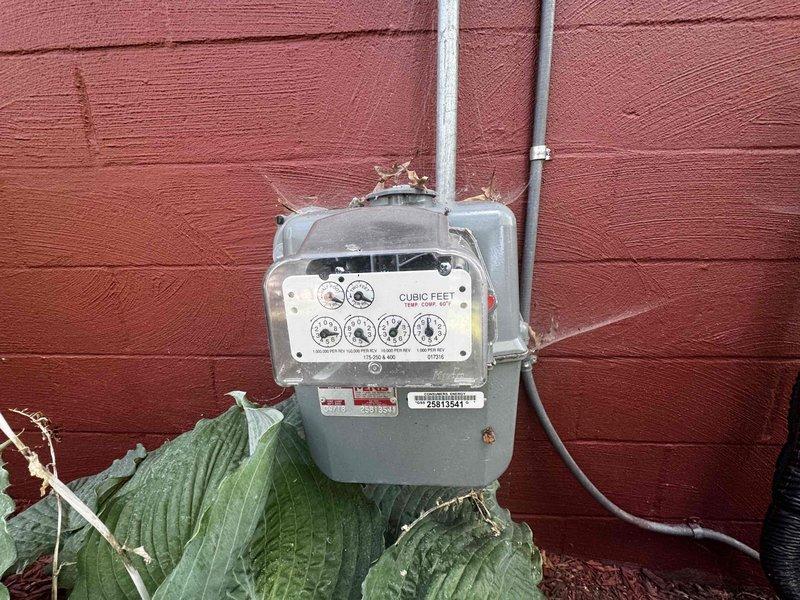 Conducted on-site evaluation for whole house generator installation at single-family residence with no existing backup power system. Assessed optimal placement location in front landscaping area near foundation, which provides adequate clearance and accessibility for equipment installation and future maintenance. Identified existing natural gas meter on exterior wall with available capacity for generator connection. Determined feasible routing path through adjacent garage area for both gas line extension and electrical connections to main service panel. Documented current electrical infrastructure and confirmed adequate space for required transfer switch installation. Photographed proposed generator placement site and gas meter location for equipment sizing and permit documentation.