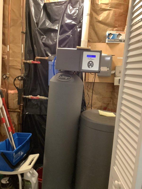 Responded to warranty callback for water heater investigation following two tank replacements within one year. Conducted thorough inspection of Culligan water softening system, associated plumbing connections, and copper supply lines with shut-off valves. Documented current installation conditions including control head operation, brine tank configuration, and piping assembly. Photographed equipment setup and plumbing connections for diagnostic review and coordination with manufacturer representative. No repairs performed during this diagnostic visit.