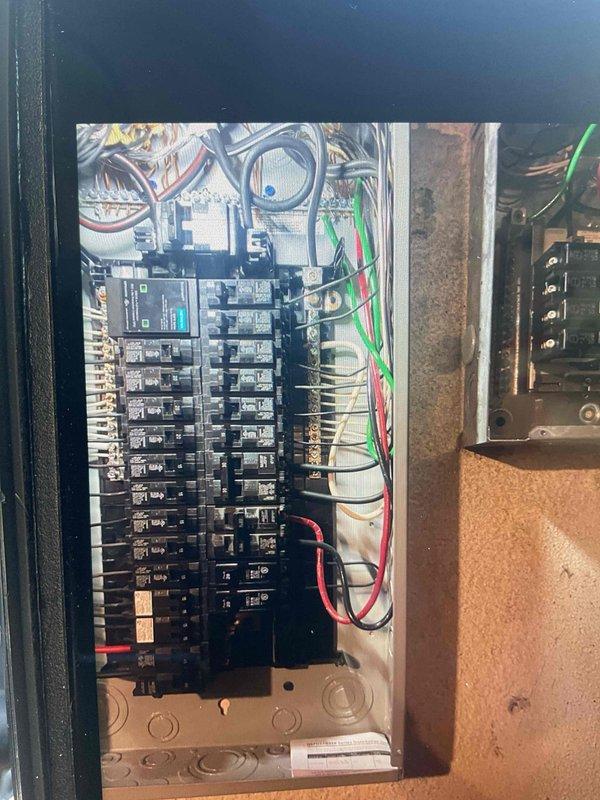 Responded to callback for electrical installation to address code violation. Corrected improper SO cord feeding panel by installing compliant wiring and connections per electrical code requirements. Verified all circuit breakers properly seated and labeled, confirmed wire connections secure at panel bus bars, and ensured proper color-coded wiring throughout distribution system. Panel now meets code compliance standards with appropriate permanent wiring installation.